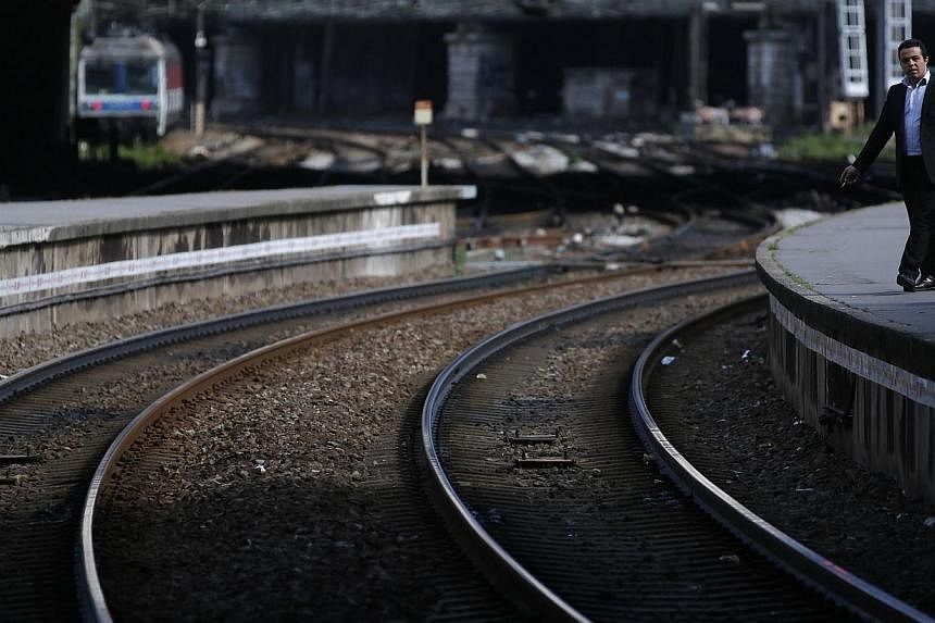 A commuter waits for a train during a nationwide strike by French SNCF railway workers at Paris Saint-Lazare station, on June 11, 2014.&nbsp;Experts tasked with investigating one of France's worst train accidents found "a state of disrepair never see