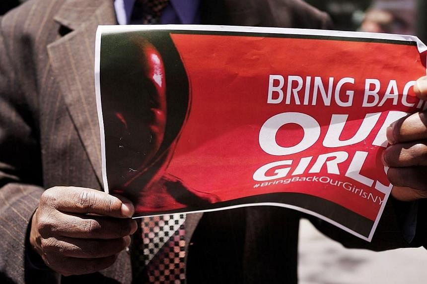 A person holds up a sign as local clergy, activists and and community leaders protest for the safe return of the 276 abducted schoolgirls outside the Permanent Mission of Nigeria to the United Nations on June 2, 2014 in New York City. -- PHOTO: AFP
