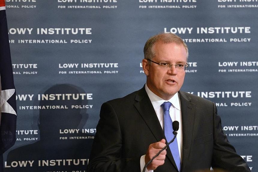 Australian Immigration Minister Scott Morrison speaks to the Lowy Institute for International Policy in Sydney on May 9, 2014. Australian border patrol personnel intercepted a Sri Lankan asylum seeker vessel west of the Cocos Islands last week and tr