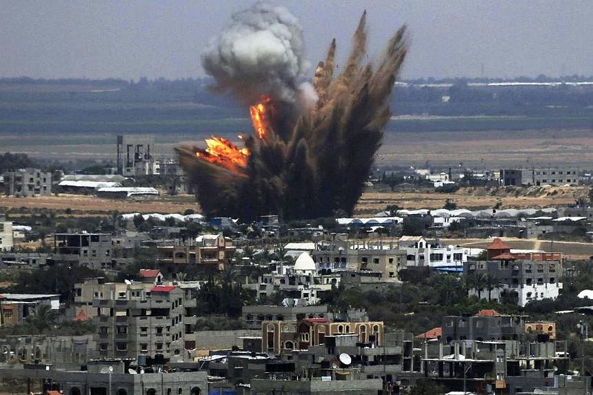 Smoke and flames are seen following what police said was an Israeli air strike in Rafah in the southern Gaza Strip July 8, 2014.&nbsp;Israeli warplanes killed 12 Palestinians Tuesday, pounding the Gaza Strip in a new campaign to stamp out Hamas rocke