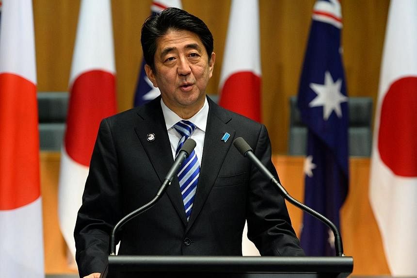 Japanese Prime Minister Shinzo Abe speaks at a joint press conference with his Australian counterpart Tony Abbott at the Parliament House in Canberra on July 8, 2014.&nbsp;Japanese Prime Minister Shinzo Abe plans to launch a female-focused version of