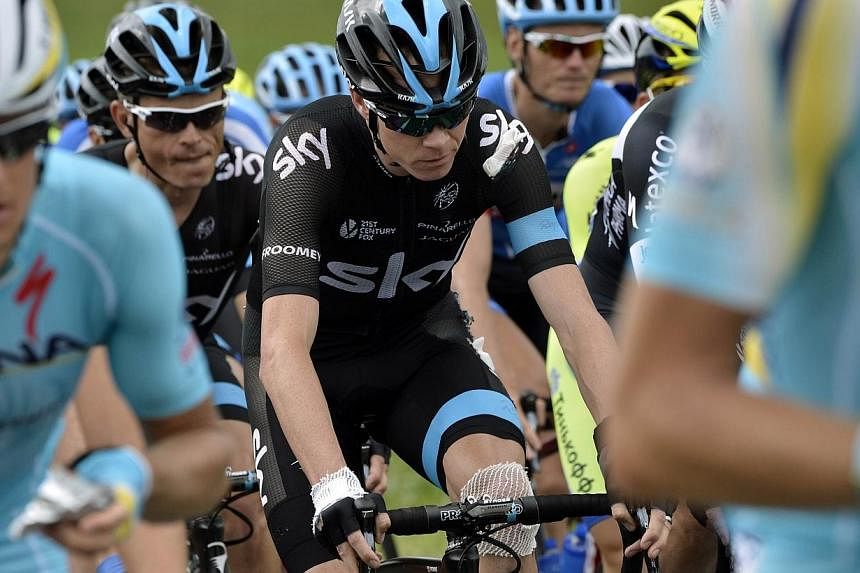 Britain's Christopher Froome injured rides in the pack after a fall during the 163.5 km fourth stage of the 101st edition of the Tour de France cycling race on July 8, 2014 between Le Touquet-Paris-Plage and Lille, nothern France.&nbsp;Defending cham