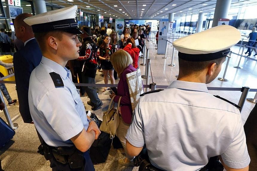 Police officers patrol at a security gate inside the main terminal of Frankfurt Airport on July 3, 2014.&nbsp;Germany has tightened security at its airports after US authorities said they were concerned that Al-Qaeda operatives in Syria and Yemen wer