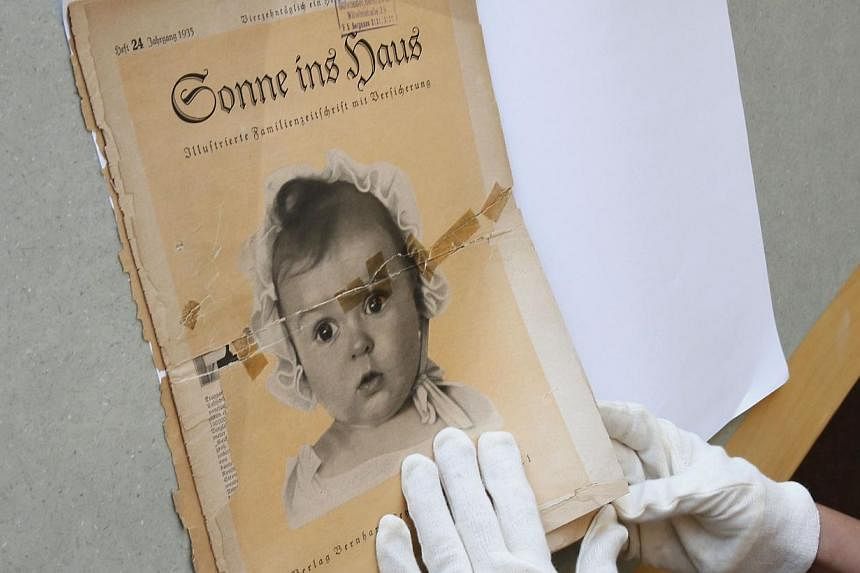 At the archives of the Yad Vashem Holocaust memorial museum on July 8, 2014, the front page of the original issue of the Nazi family magazine "Sonnie ins Hous" (Sunshine in the House) shows baby Hessy Taft as the ideal German Aryan baby as part of Na
