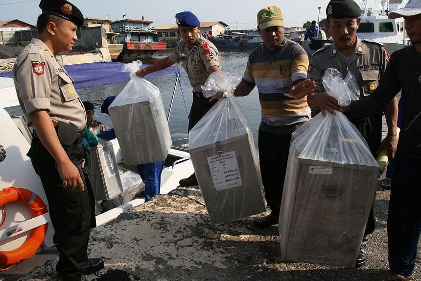 In this photograph taken on July 7, 2014, Indonesian police delivers by maritime police boat ballot boxes and polling materials to Gili Ketapang island located off East Java province ahead of the July 9, 2014 presidential election closely contested b