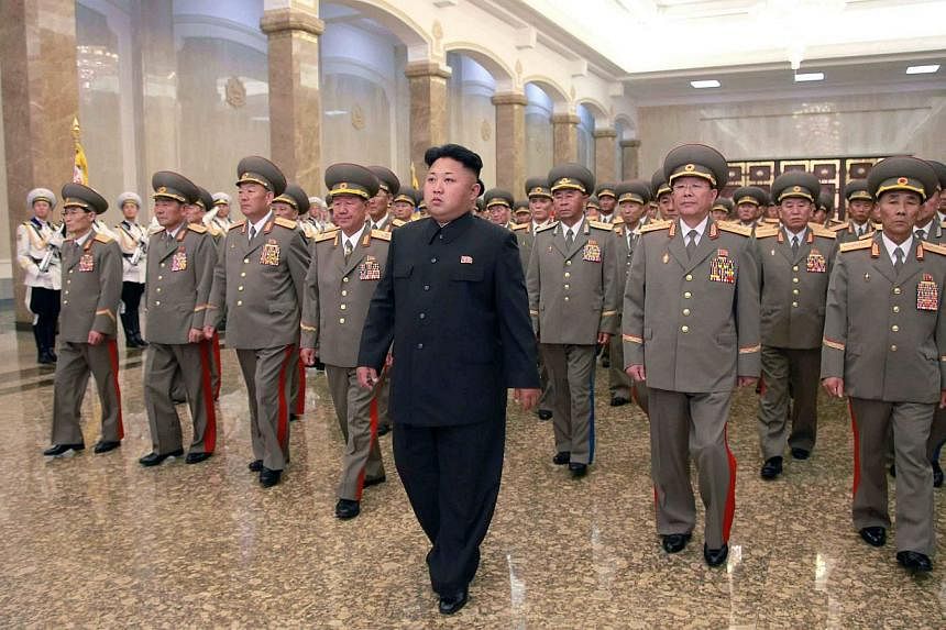 North Korean leader Kim Jong Un (centre) visits the Kumsusan Palace of the Sun at midnight on Tuesday on the occasion of the 20th anniversary of the demise of President Kim Il Sung, in this photo released by North Korea's Korean Central News Agency (