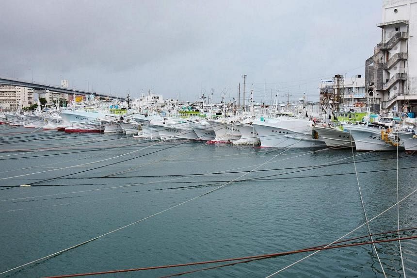 Fishing boats are moored at Tomari port in Naha on Japan's southern island of Okinawa as super typhoon Neoguri approaches the region, in this photo taken by Kyodo July 7, 2014. A super typhoon described as a "once in decades storm" was heading north 