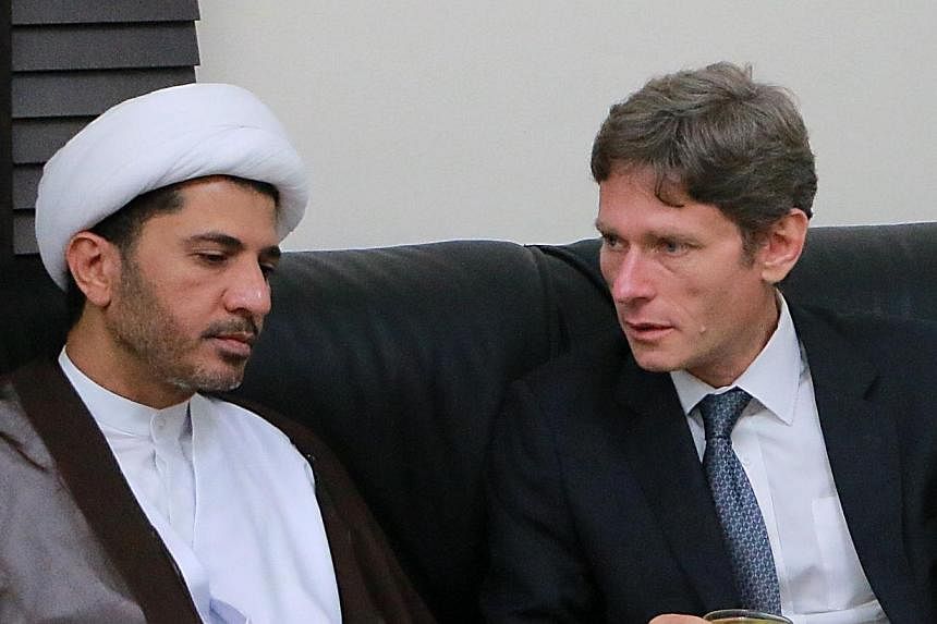 A handout picture released by Bahrain's main opposition Al-Wefaq group on July 7, 2014 shows US Assistant Secretary of State for Democracy, Human Rights and Labour, Tom Malinowski (right) meeting with Bahrain's Al-Wefaq opposition group leader Sheikh
