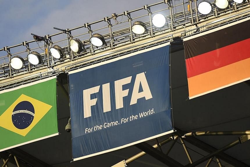 Germany's (right) and Brazil's (left) flags are displayed next to the FIFA flag at The Mineirao Stadium in Belo Horizonte on July 7, 2014 on the eve of the 2014 FIFA World Cup semi-final between Germany and Brazil. -- PHOTO: AFP