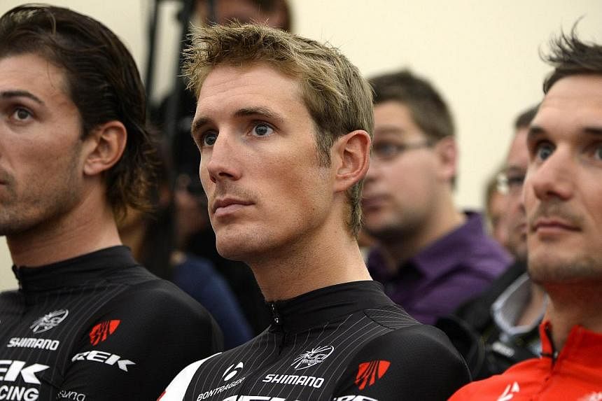 (From left) Switzerland's Fabian Cancellara, Luxembourg's Andy Schleck and his brother Frank Schleck take part in a press conference of the USA's Trek Factory cycling team on July 3, 2014, at the press center in Leeds, England, before the start of th