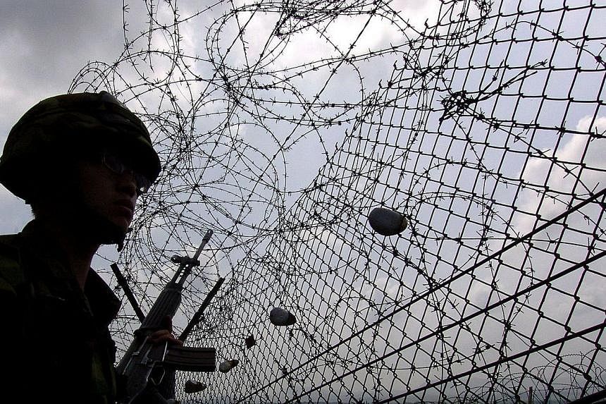 A file photo taken on July 7, 2006, shows a South Korean soldier near the barbed wire of the Demilitarized Zone (DMZ) separating North and South Korea, in Paju.&nbsp;North Korean soldiers have crossed the inter-Korean armistice line into South Korea 