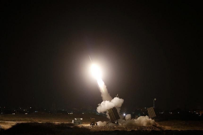An Iron Dome launcher fires an interceptor rocket in the southern Israeli city of Ashdod July 8, 2014.&nbsp;At least five rockets fired from Gaza were shot down over Tel Aviv and the surrounding area on Wednesday, army radio said. -- PHOTO: REUTERS