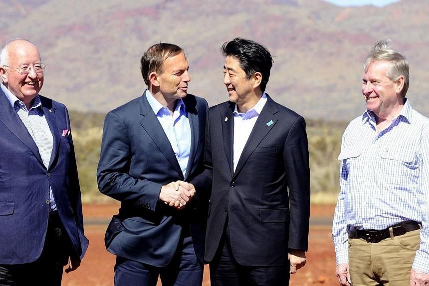 Australia's Prime Minister Tony Abbott (2nd left) and his Japanese counterpart Shinzo Abe (2nd right) along with Rio Tinto CEO Sam Walsh (left) and Western Australia's Premier Colin Barnett (right) arrive for a tour of mining giant Rio Tinto's West A