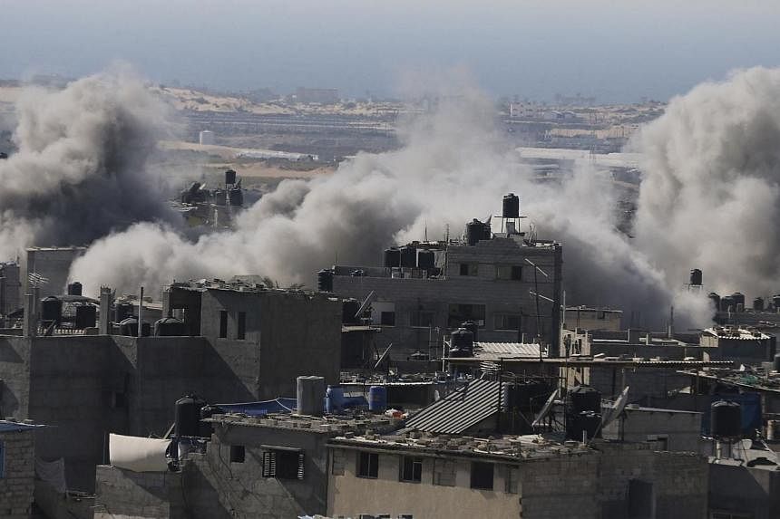 Smoke is seen following what police said was an Israeli air strike in Rafah in the southern Gaza Strip on July 9, 2014.&nbsp;Fifteen women and children were among 22 Palestinians killed in Israeli strikes on Gaza Wednesday, hiking the overall death t