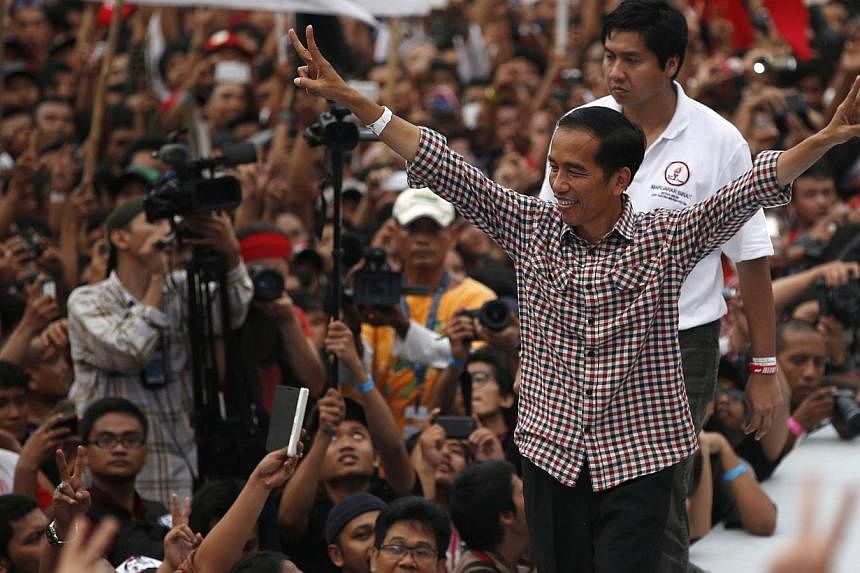 Indonesian presidential candidate Joko "Jokowi" Widodo gestures to his supporters after delivering a speech at Gelora Bung Karno stadium in Jakarta on July 5, 2014.&nbsp;Jakarta Governor Joko Widodo declared victory on Wednesday, July 9, 2014, in Ind