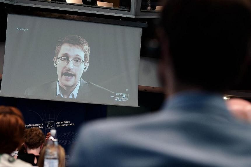 US National Security Agency (NSA) whistleblower Edward Snowden speaks to European officials via videoconference during a parliamentary hearing on improving the protection of whistleblowers, at the Council of Europe in Strasbourg, eastern France on Ju