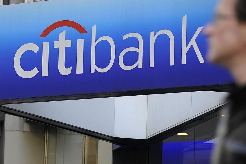 A man walks by a Citibank branch at the US bank Citigroup world headquarters on Park Avenue, in New York, in this Nov 17, 2008 file photo.&nbsp;Citigroup is close to paying about US$7 billion (S$8.7 billion) to resolve a US probe into whether it defr