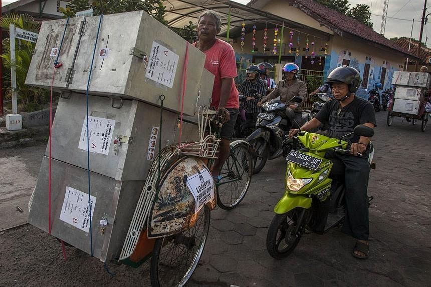 Ballot boxes are delived by Becak transport, traditional Indonesian public commuter ride, to voting centers in Yogyakarta in central Java island on July 8, 2014 ahead of the presidential poll.&nbsp;Indonesians vote on Wednesday in the country’s tig