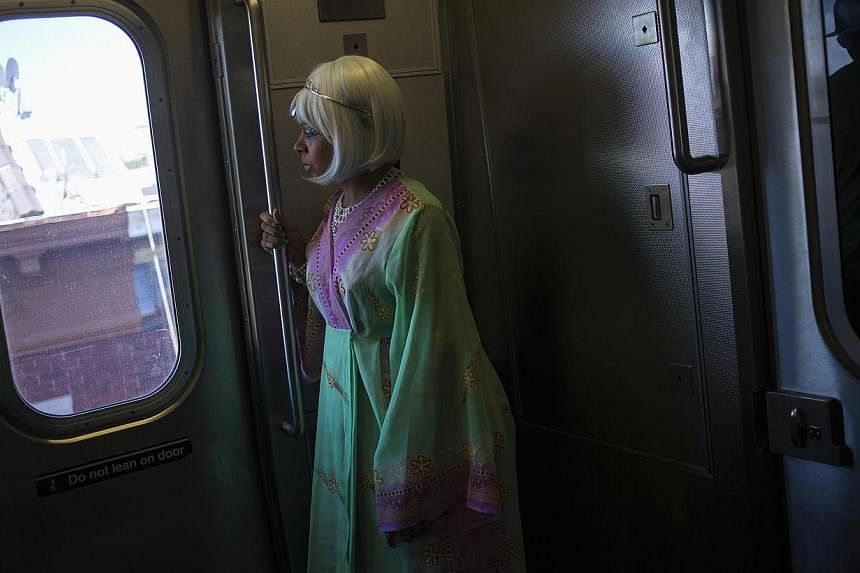 A woman rides the subway before the Mermaid Parade at Coney Island in the Brooklyn section of New York on June 21, 2014.&nbsp;A young homeless woman accused of abandoning her baby on a crowded subway platform in the heart of Manhattan was charged in 