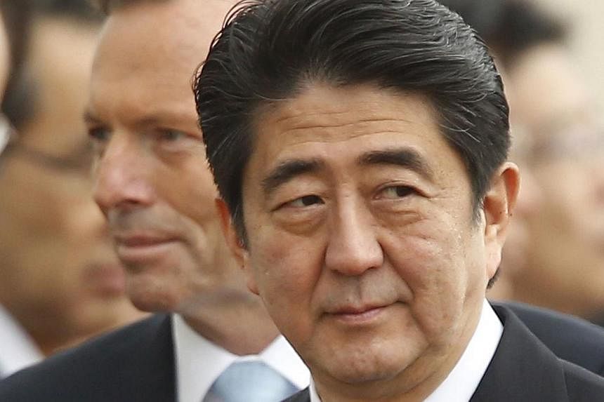 Japan's Prime Minister Shinzo Abe (right) participates in an official arrival ceremony with Australian Prime Minister Tony Abbott (back left) at Parliament House in Canberra on July 8, 2014.&nbsp;Japanese Prime Minister Shinzo Abe has been personally