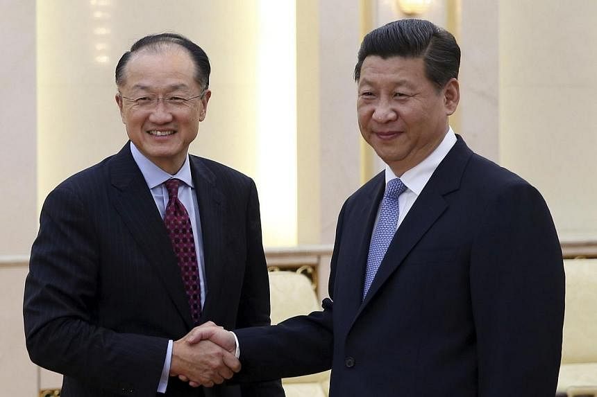 China's President Xi Jinping (right) shakes hands with World Bank Group President Jim Yong Kim during their meeting in Beijing, on July 8, 2014. Confrontation between China and the United States would be a disaster, Chinese President Xi Jinping said 
