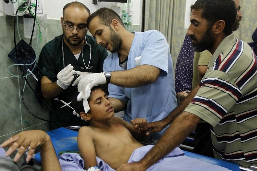 A wounded Palestinian child is treated by medics at al-Najar hospital in Rafah, in the southern Gaza Strip on July 9, 2014.&nbsp;Egypt opened its Rafah border crossing to Gaza on Thursday, July 10, 2014, to receive wounded Palestinians as Israel poun