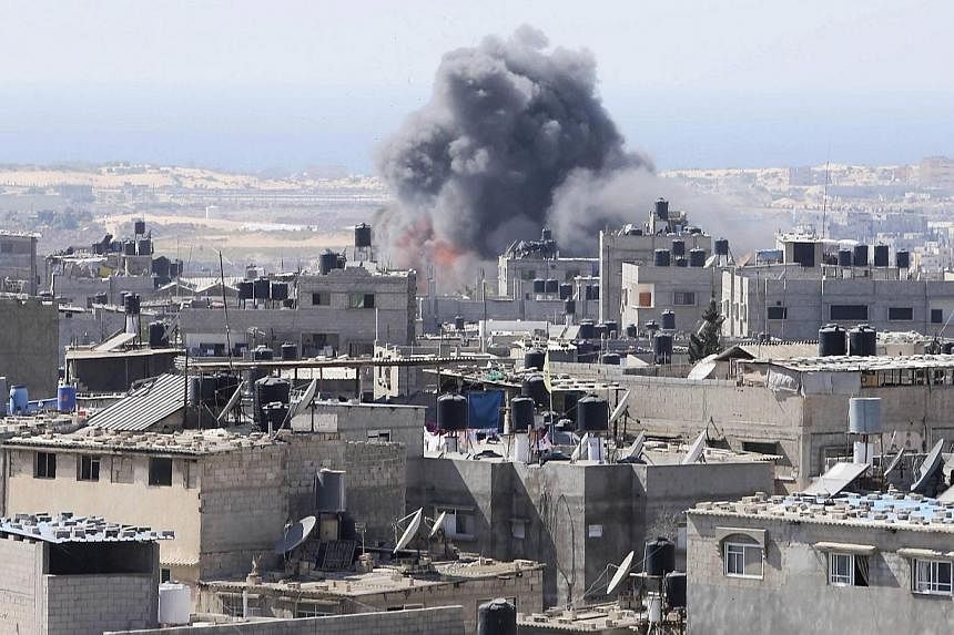 Smoke and flames are seen following what Palestinian witnesses said was an Israeli air strike in Rafah in the southern Gaza Strip on July 10, 2014. UN chief Ban Ki-moon appealed Thursday for a ceasefire between Israel and Palestinian militants, calli