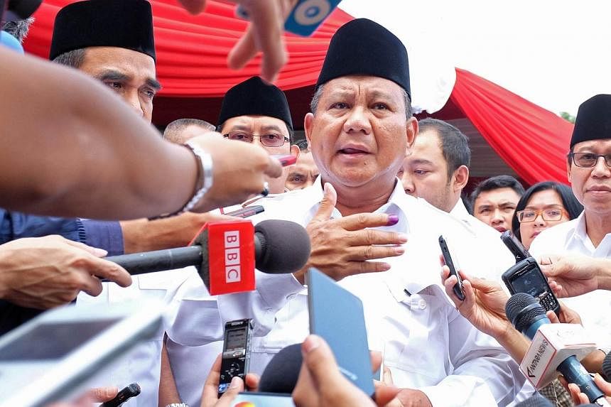 Indonesian presidential candidate Prabowo Subianto speaks to the media after voting at a polling station in the village of Bojong Koneng in Bogor, West Java province on July 9, 2014. -- PHOTO: AFP