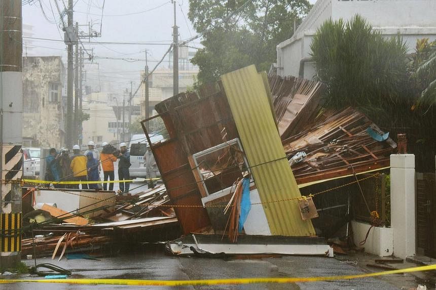 A wooden house which collapsed due to strong winds caused by Typhoon Neoguri is seen in Naha, on Japan's southern island of Okinawa, in this photo taken by Kyodo on July 8, 2014. -- PHOTO: REUTERS
