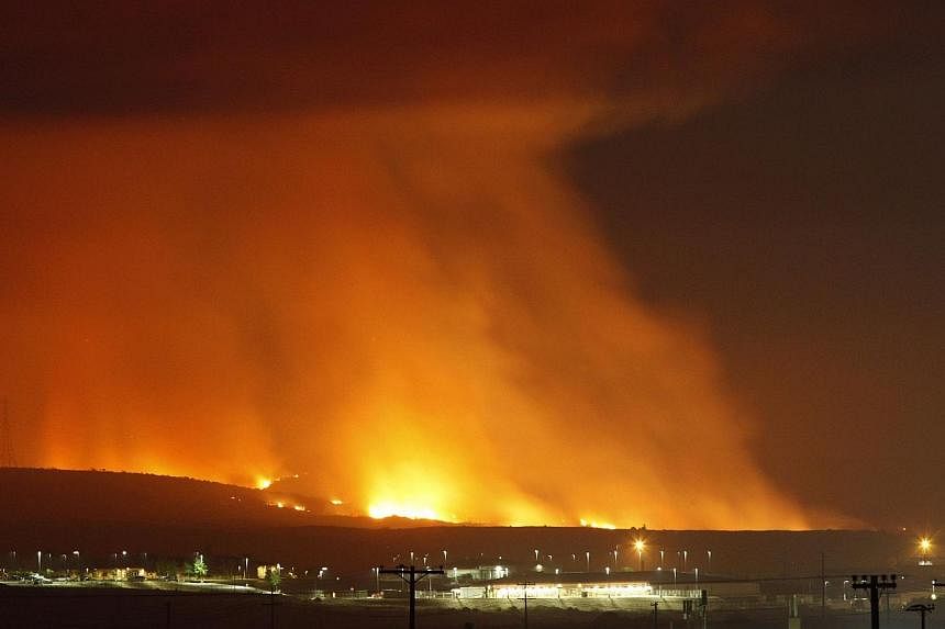 The Las Pulgas Fire lights the night on May 16, 2014 at Camp Pendleton, California. Investigators have determined that it was a youth who intentionally started a destructive fire that teared through southern California in May, destroying dozens of ho
