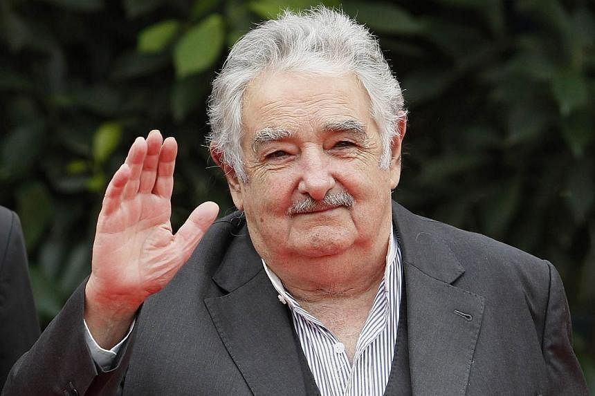 Uruguay's President Jose Mujica waves to the media during the ceremonial greeting of heads of states at the G77+ China Summit in Santa Cruz de la Sierra on June 15, 2014.&nbsp;Uruguay President Jose Mujica told AFP on Wednesday that sales of marijuan