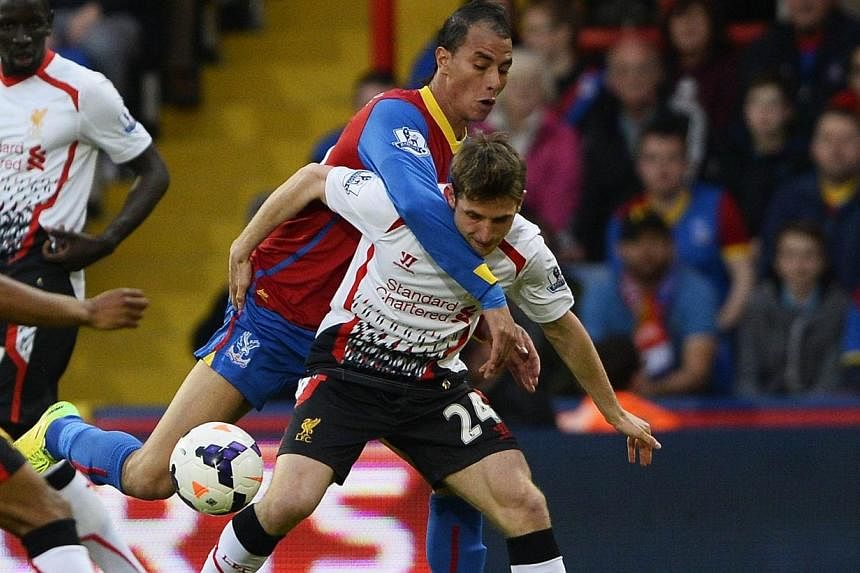Crystal Palace's Marouane Chamakh (left) challenges Liverpool's Joe Allen during their English Premier League soccer match at Selhurst Park in London on May 5, 2014.&nbsp;Chamakh has signed a new two-year contract at Crystal Palace, the English Premi