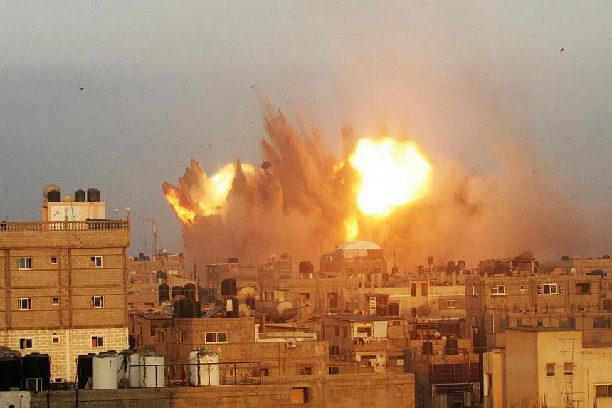 A ball of fire is seen following an early morning Israeli air strike on July 11, 2014, on Rafah in the southern of Gaza strip.&nbsp;Israel could be violating the laws of war by bombing Palestinian homes in Gaza, the UN's human rights office said Frid