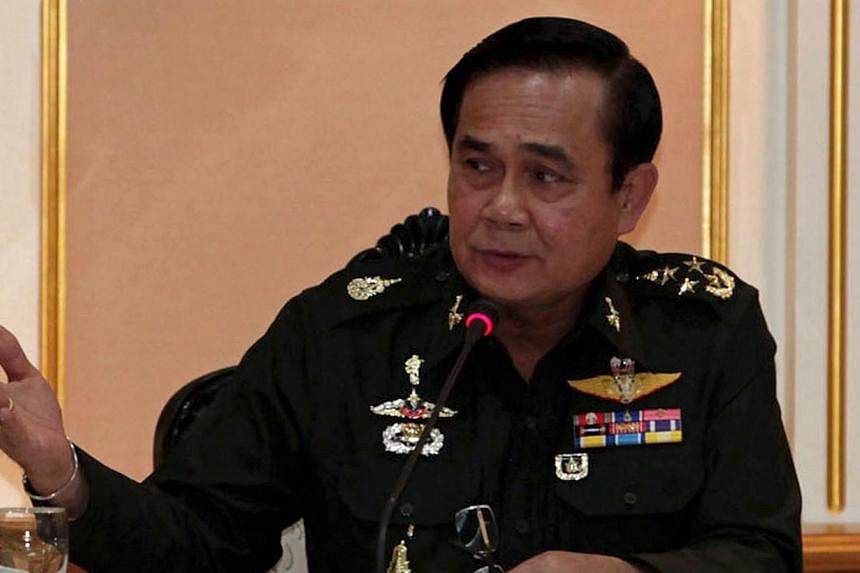 This handout photo taken on June 19, 2014 shows Thai junta chief General Prayut Chan-O-Cha gesturing as he speaks during a meeting with businessmen at the Army headquarter in Bangkok.&nbsp;Thailand's junta said Friday, July 11, 2014, that it would ke