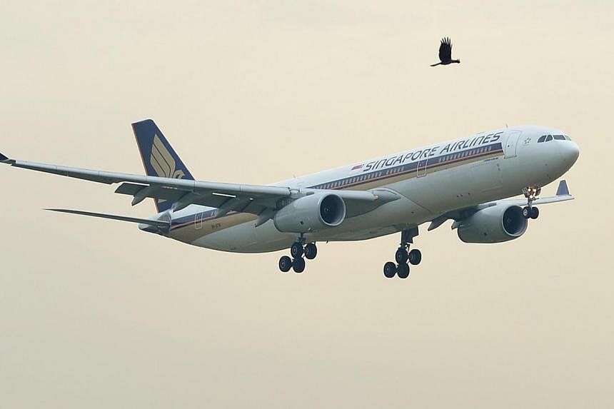 The use of laptops, tablets and other electronic devices is now allowed on Singapore Airlines flights from the time of boarding until disembarkation. -- PHOTO: ST FILE