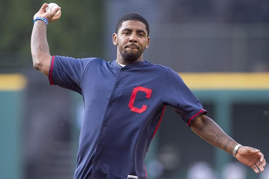 Kyrie Irving of the NBA Cleveland Cavaliers throws out the first pitch prior to the game between the Cleveland Indians and the Los Angeles Angels of Anaheim at Progressive Field in Cleveland, Ohio&nbsp;on June 16, 2014. -- PHOTO: AFP