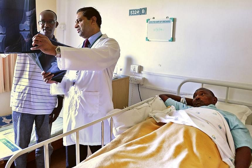 A doctor showing an X-ray to the attendant of a Nigerian patient who underwent surgery at the Apollo Hospital in Chennai. Australian doctor David Berger has stirred up a debate about corruption in Indian health care with an article in the British Med