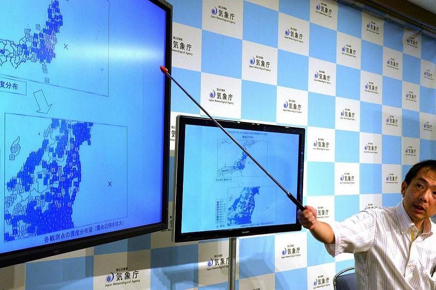 Japan Meteorological Agency officer Yasuhiro Yoshida speaks during a press conference in Tokyo on July 12, 2014, after a strong 6.8 magnitude earthquake struck off the country's Pacific coast. -- PHOTO: AFP