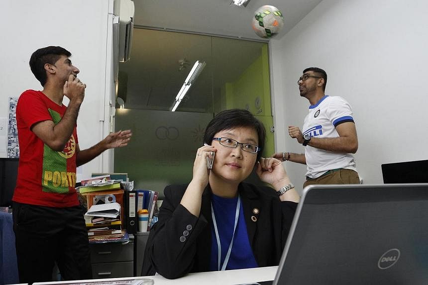 Ms Juliet Soh (centre), an IT marketer, shares office space with D2D Sports’ Mr Alvinder Singh (left) and Mr Rasvinder Singh (right) at The Office. -- PHOTO: DESMOND LUI FOR THE SUNDAY TIMES