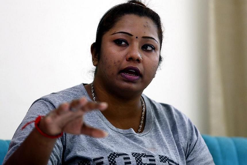 Deepa Subramaniam, 30, leaves after an interview in Petaling Jaya, near Kuala Lumpur July 3, 2014. Subramaniam's estranged spouse converted from Hinduism to Islam in 2012, after their nine-year marriage broke down, taking the name Izwan Abdullah. -- 