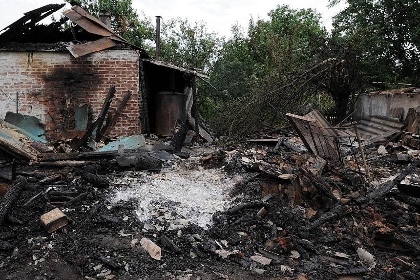 A picture taken on July 13, 2014, shows a house destroyed after yesterday's bombardments carried out by Ukrainian armed forces in the village of Maryinka, 20 km southwest of Donetsk.&nbsp;Moscow on Sunday warned Kiev of "irreversible consequences" af