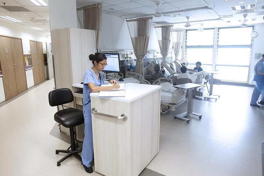 A nurse working at a dedicated working space in a new ward, with brighter lighting and a more spacious feel, at Tan Tock Seng Hospital (TTSH) on May 22, 2014.&nbsp;Those with Integrated Shield Plans (IP) will all stand to benefit from the implementat