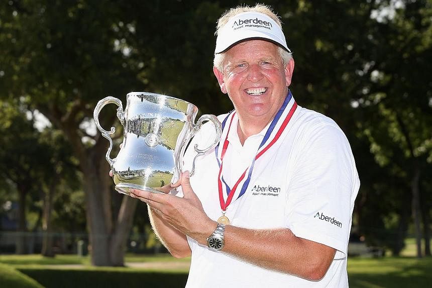 Colin Montgomerie of Scotland poses with the winner's trophy after winning the 2014 U.S. Senior Open Championship in the final round at Oak Tree National on July 13, 2014 in Edmond, Oklahoma.&nbsp;Montgomerie won the US$3.5 million (S$4.3 million) US