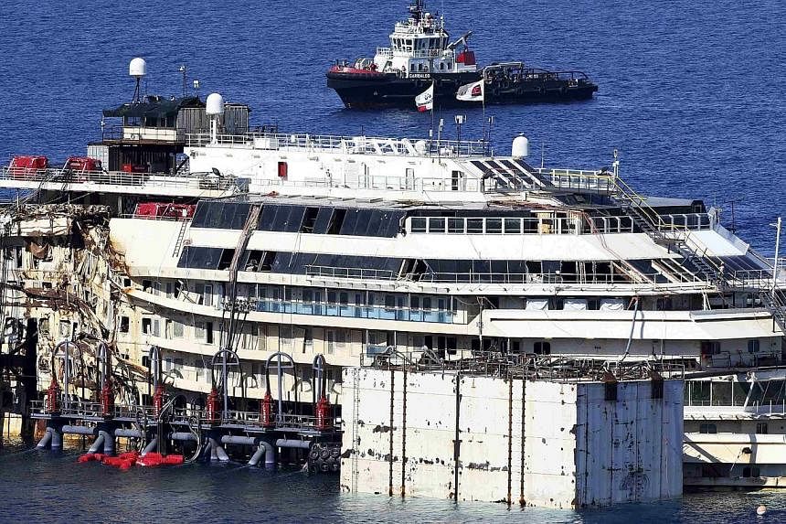 The cruise liner Costa Concordia is seen at Giglio harbour, Giglio Island on July 13, 2014.&nbsp;An unprecedented operation to refloat the shipwrecked Costa Concordia has begun in Italy, with salvage workers attempting to raise the rusty liner from i