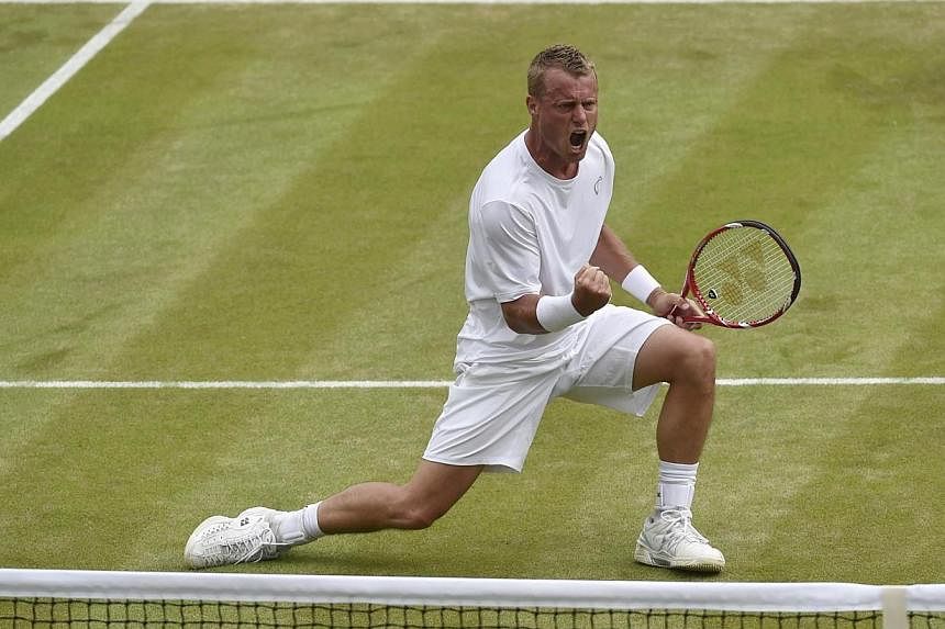 Lleyton Hewitt of Australia celebrates winning the fourth set during his men's singles match against Jerzy Janowicz of Poland at the Wimbledon Tennis Championships, in London on June 27, 2014.&nbsp;Former world number one Lleyton Hewitt defeated seco