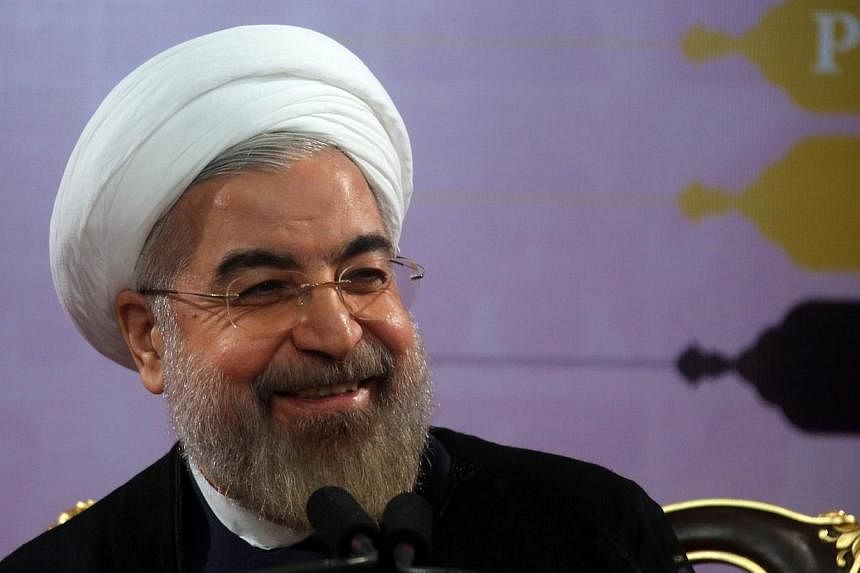 Iranian President Hassan Rouhani speaks during a press conference in the capital Tehran on June 14, 2014.&nbsp;Iran's President Hassan Rouhani should be trusted over Teheran's nuclear programme, but he must be judged on his actions not words, British
