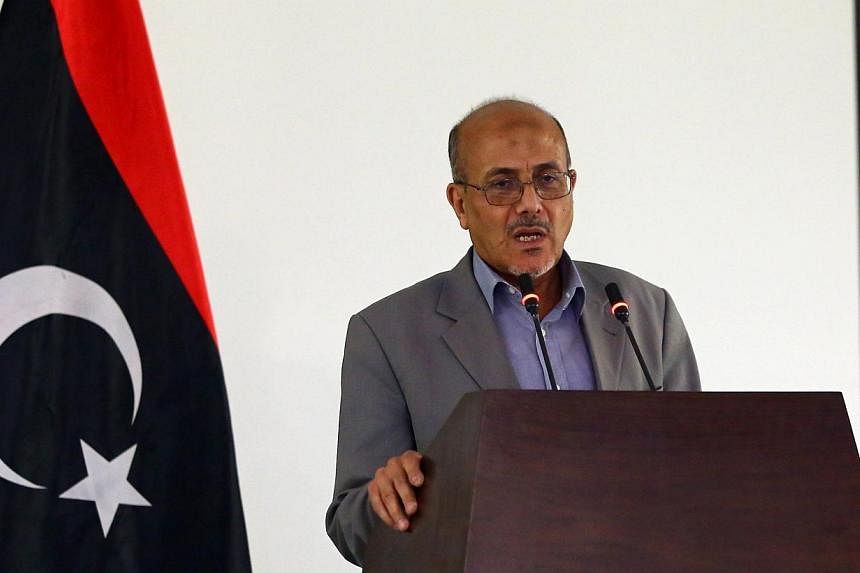 Libyan government's spokesman Ahmad Lamen holds a press conference in the capital Tripoli on July 13, 2014, as deadly clashes rage around the country's main international airport.&nbsp;The United Nations said on Sunday it had temporarily relocated so