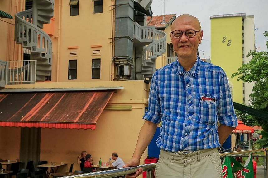 Retiree James Seah standing in front of the MCA (Malayan Chinese Association) shophouses, the only building structures that survived the 1961 Bukit Ho Swee fire. He will be leading heritage trails in the area. -- PHOTO: DRAMA BOX