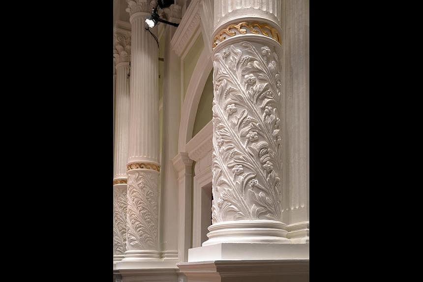 After the makeover, the Victoria Theatre and Concert Hall (above) has a restored passageway (top) from 1905 and intricately carved pillars (right).
