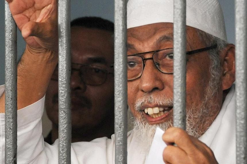 Although Abu Bakar Bashir, the jailed spiritual leader of South-east Asia's terrorist network, only recently voiced his support for the Islamic State in Iraq and Syria (ISIS), his network is already financing and fighting for the group. -- PHOTO: AFP